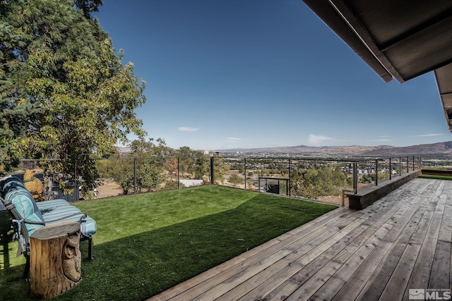 view of yard featuring a deck with mountain view