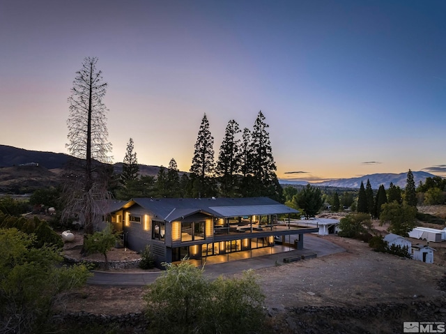 back house at dusk featuring a mountain view