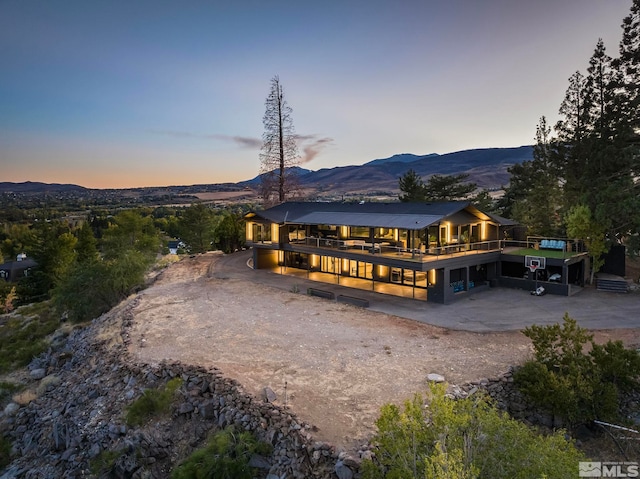 back house at dusk featuring a mountain view