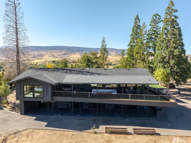 rear view of house with a mountain view and a carport