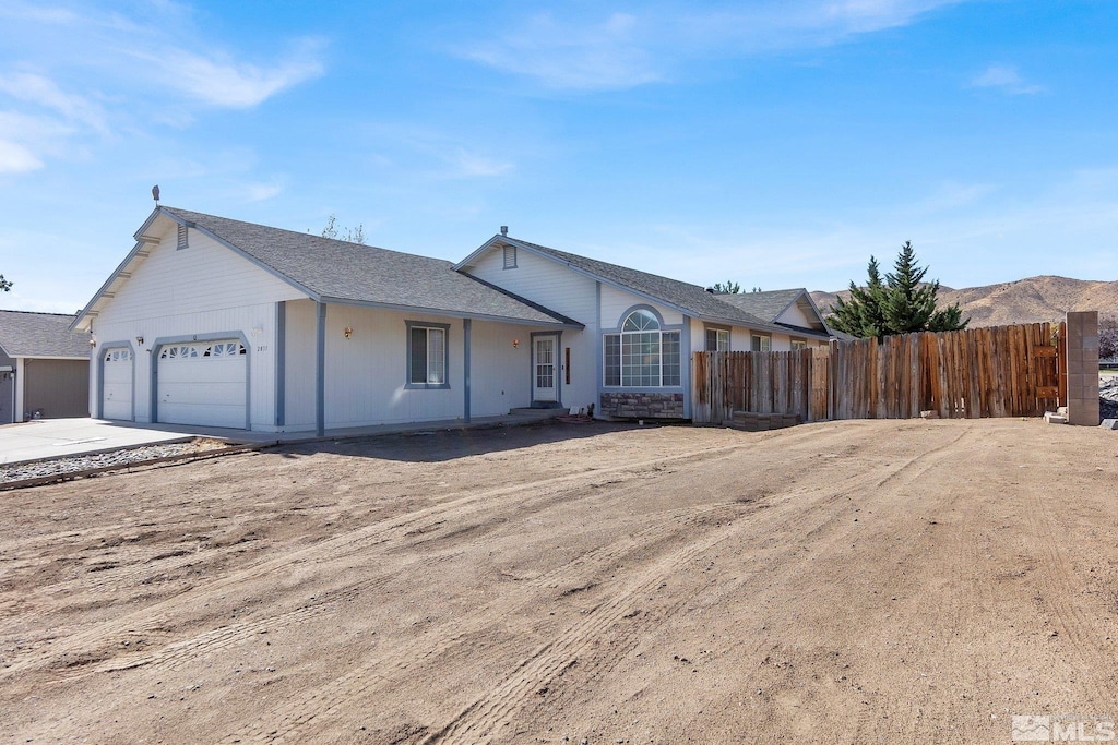 single story home featuring a garage and a mountain view