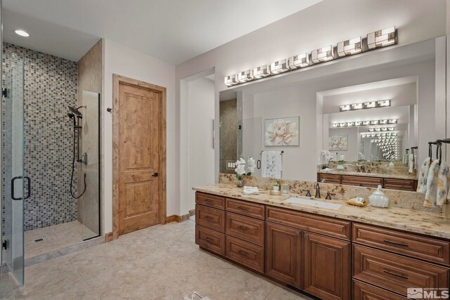 bathroom featuring vanity, tile patterned floors, and an enclosed shower