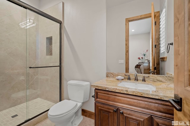 bathroom featuring vanity, toilet, tile patterned floors, and walk in shower