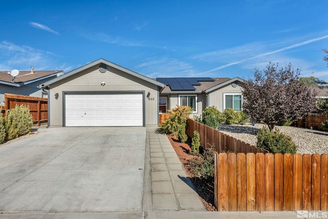 ranch-style home with solar panels and a garage