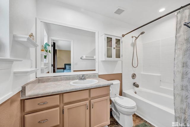 full bathroom with vanity, shower / tub combo with curtain, and toilet