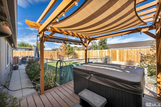 wooden terrace featuring area for grilling and a hot tub