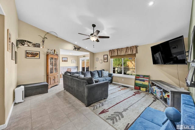 living room featuring vaulted ceiling, light tile patterned flooring, and ceiling fan