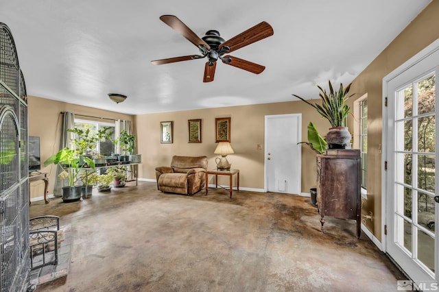 living area with ceiling fan and plenty of natural light