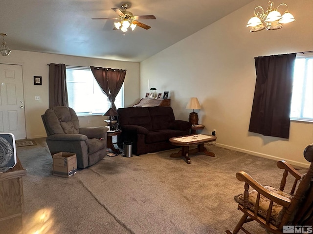 living room with a healthy amount of sunlight, carpet, and ceiling fan with notable chandelier