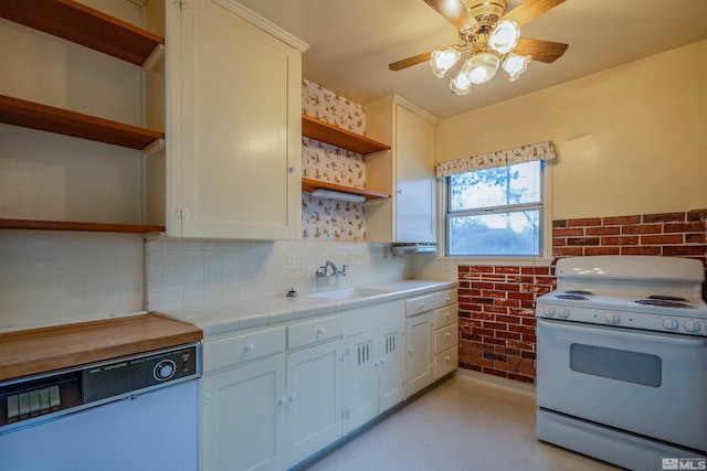 kitchen with white range, sink, tile countertops, dishwasher, and white cabinets