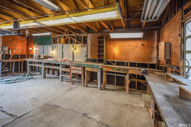 misc room featuring a workshop area and concrete flooring