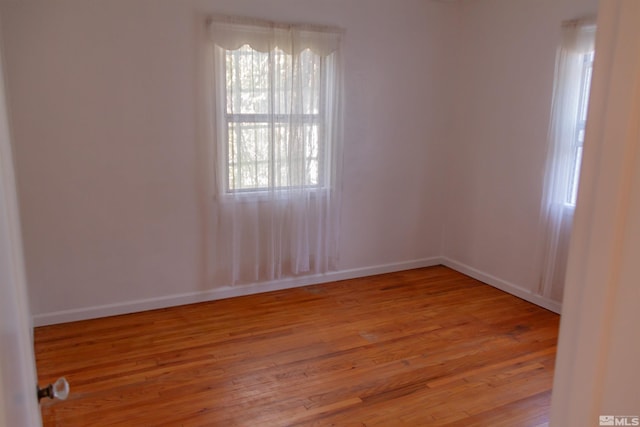 spare room with light hardwood / wood-style flooring