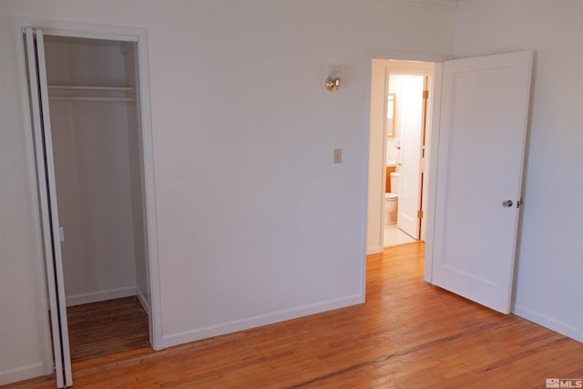 unfurnished bedroom with a closet and light hardwood / wood-style flooring