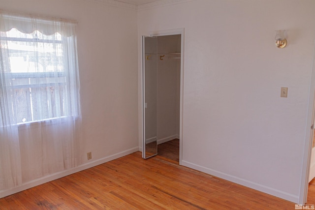 unfurnished bedroom featuring light wood-type flooring and a closet