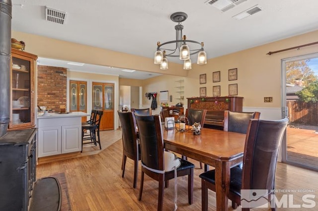 dining space featuring a chandelier and light wood-type flooring