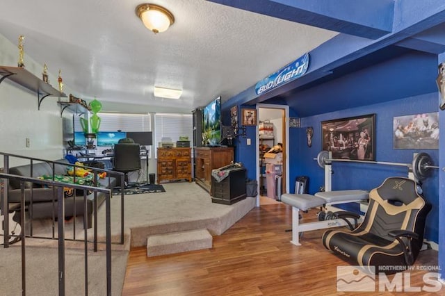 interior space featuring a textured ceiling and hardwood / wood-style floors