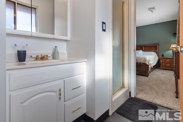 bathroom featuring vanity and a shower with shower door