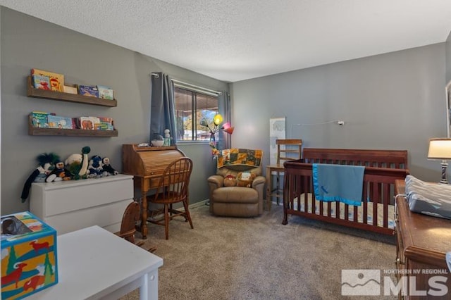 bedroom featuring a textured ceiling, a nursery area, and light colored carpet