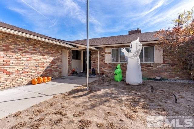 rear view of property featuring a patio