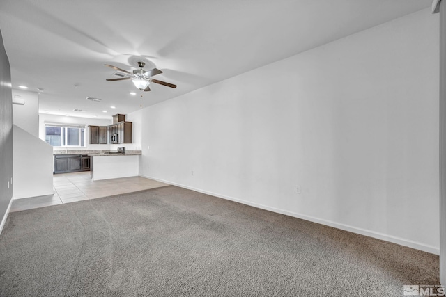 unfurnished living room with ceiling fan and light colored carpet