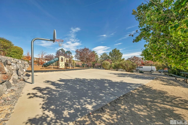 view of sport court featuring a playground