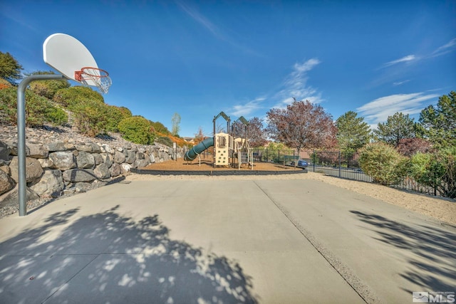 view of sport court with a playground