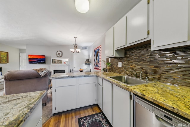 kitchen featuring decorative backsplash, white cabinetry, stainless steel dishwasher, dark wood-type flooring, and sink