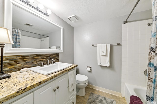 full bathroom with backsplash, shower / bath combo, toilet, vanity, and tile patterned flooring