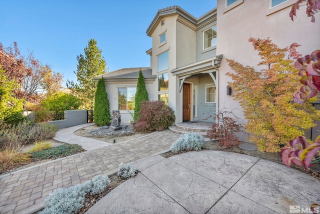 entrance to property featuring a patio area