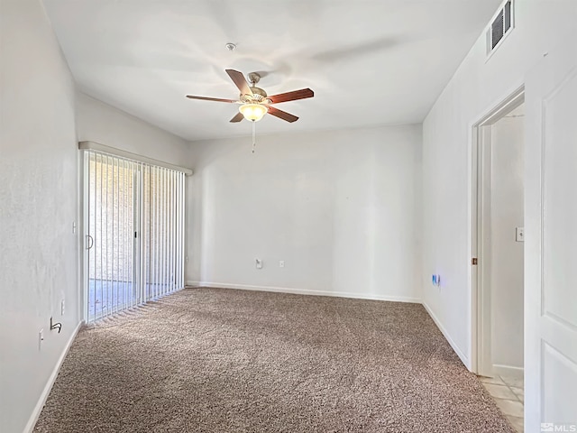 carpeted empty room featuring ceiling fan