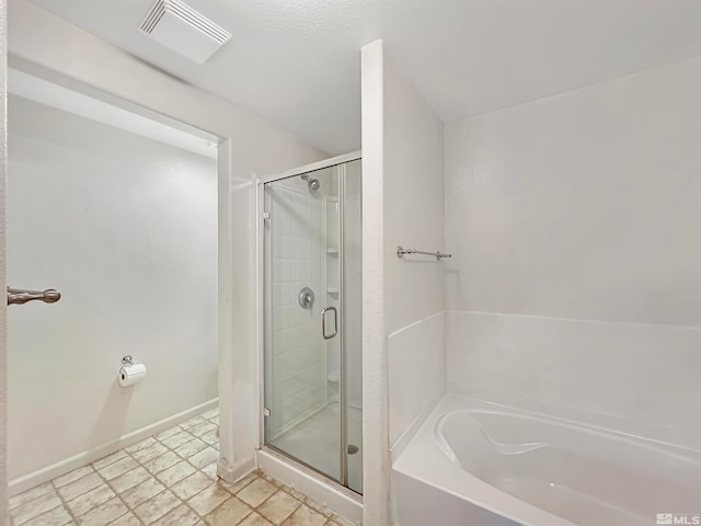 bathroom featuring separate shower and tub