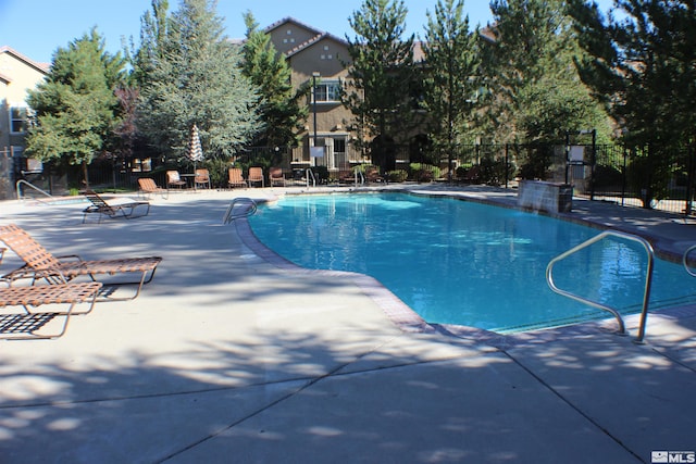 view of swimming pool with a patio area