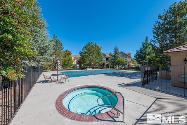 view of pool featuring a hot tub