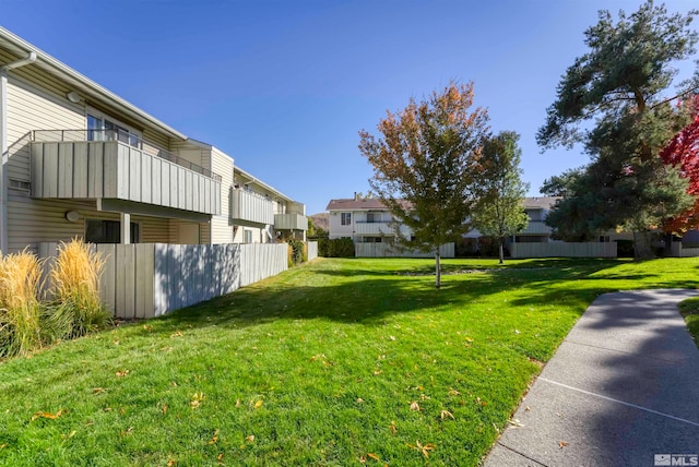 view of yard with a balcony