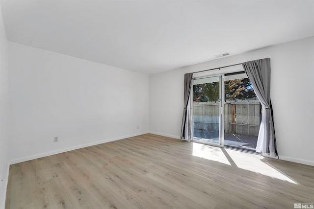 unfurnished room with light hardwood / wood-style floors