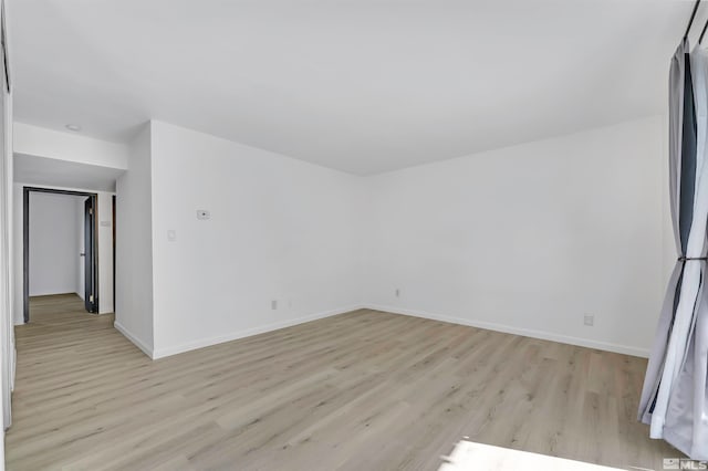 unfurnished room with light hardwood / wood-style floors