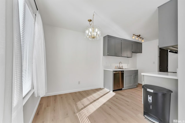 kitchen featuring light hardwood / wood-style floors, dishwasher, a chandelier, and decorative light fixtures