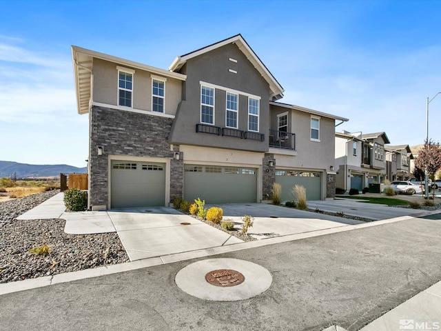 view of front of property featuring a garage and a mountain view