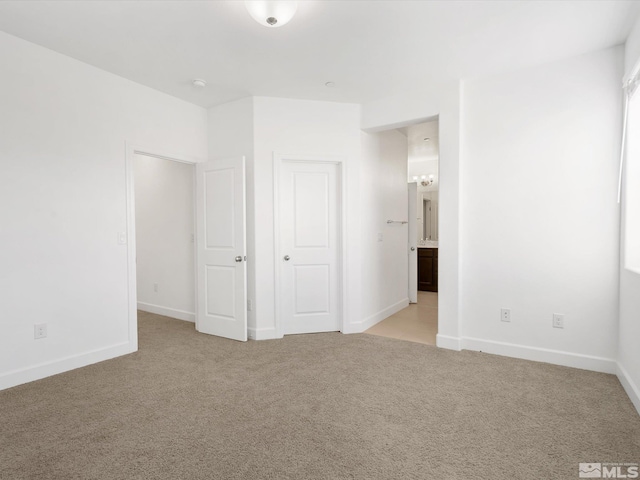 unfurnished bedroom featuring light colored carpet