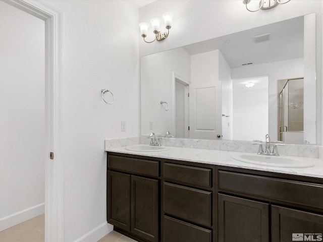 bathroom featuring vanity, an enclosed shower, and tile patterned flooring