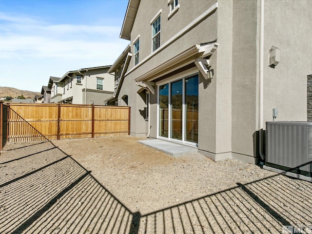 rear view of property featuring cooling unit and a patio