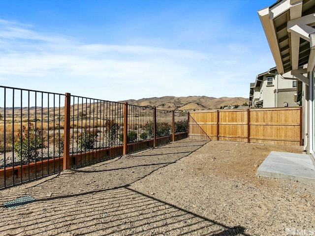 view of yard featuring a mountain view and a patio area