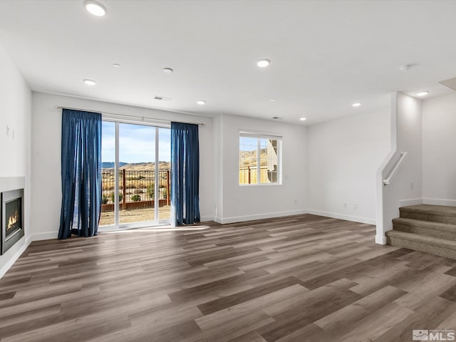 unfurnished living room featuring hardwood / wood-style floors