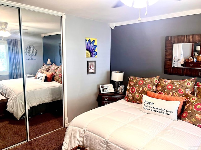 bedroom with a closet, ornamental molding, carpet, and ceiling fan