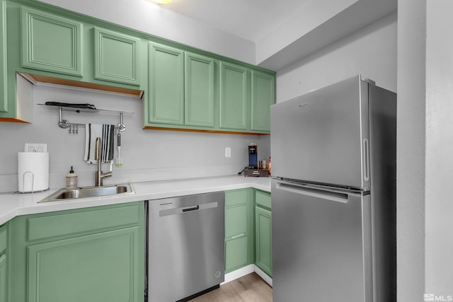 kitchen with stainless steel appliances, light countertops, and a sink