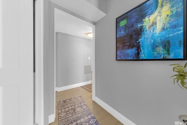hallway with baseboards and light wood-style flooring