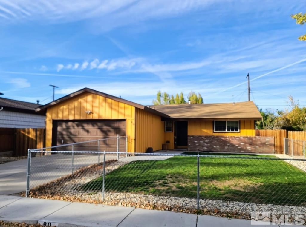 single story home featuring a front yard and a garage