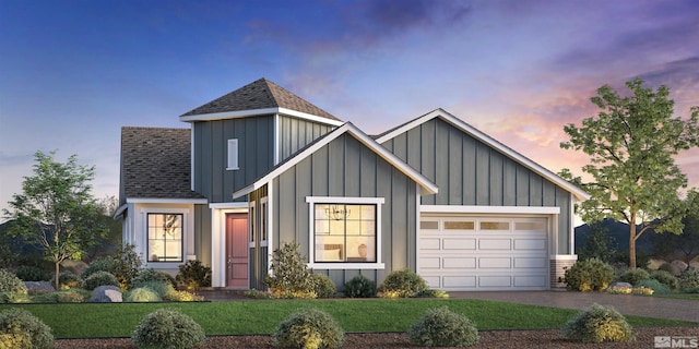 view of front facade with a yard and a garage