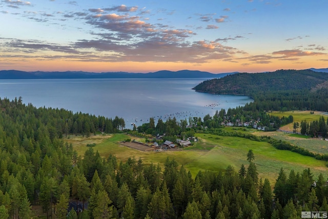 aerial view at dusk with a water and mountain view