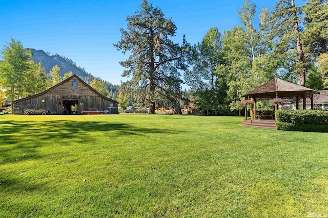 view of yard featuring a gazebo and a mountain view